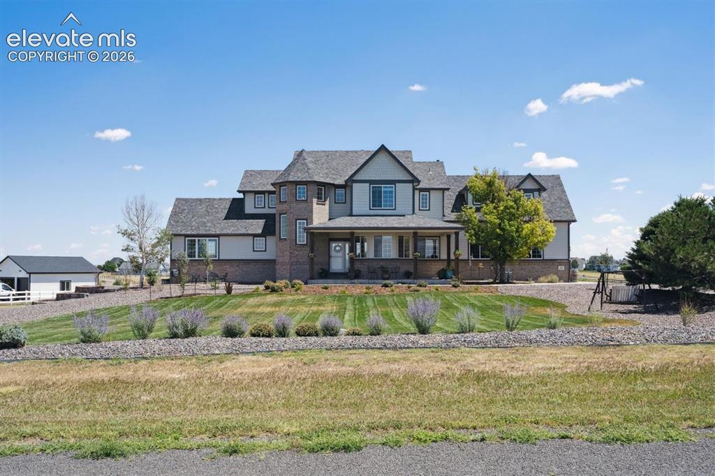 Image 1 of 46: Two-story residence featuring a multi-gable roofline and varied exterior fi