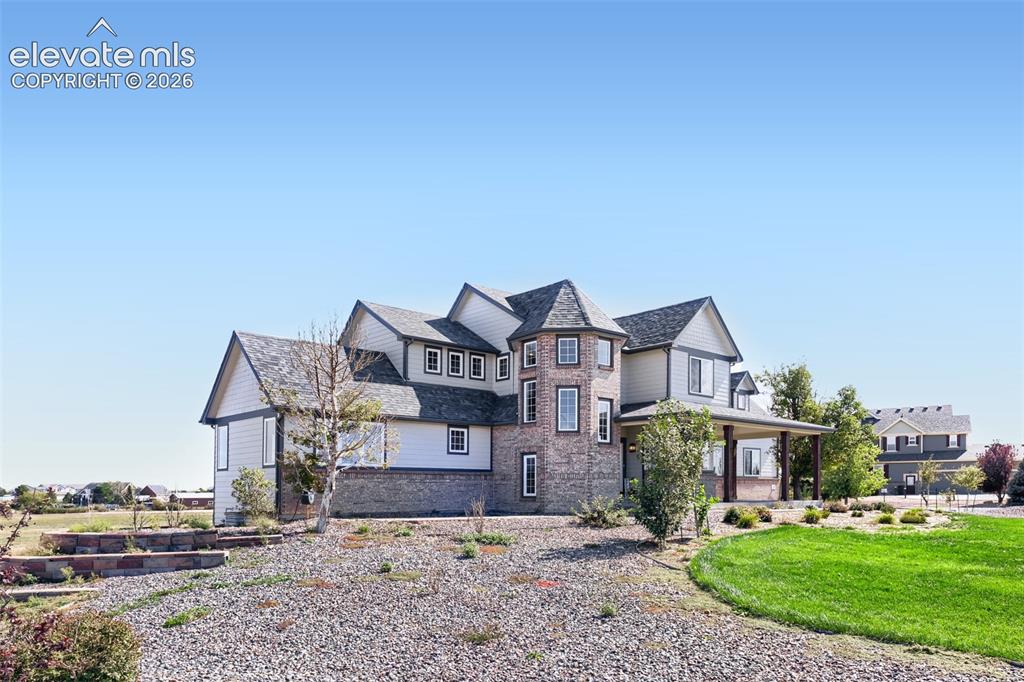 Image 2 of 37: A captivating side-front view of the home