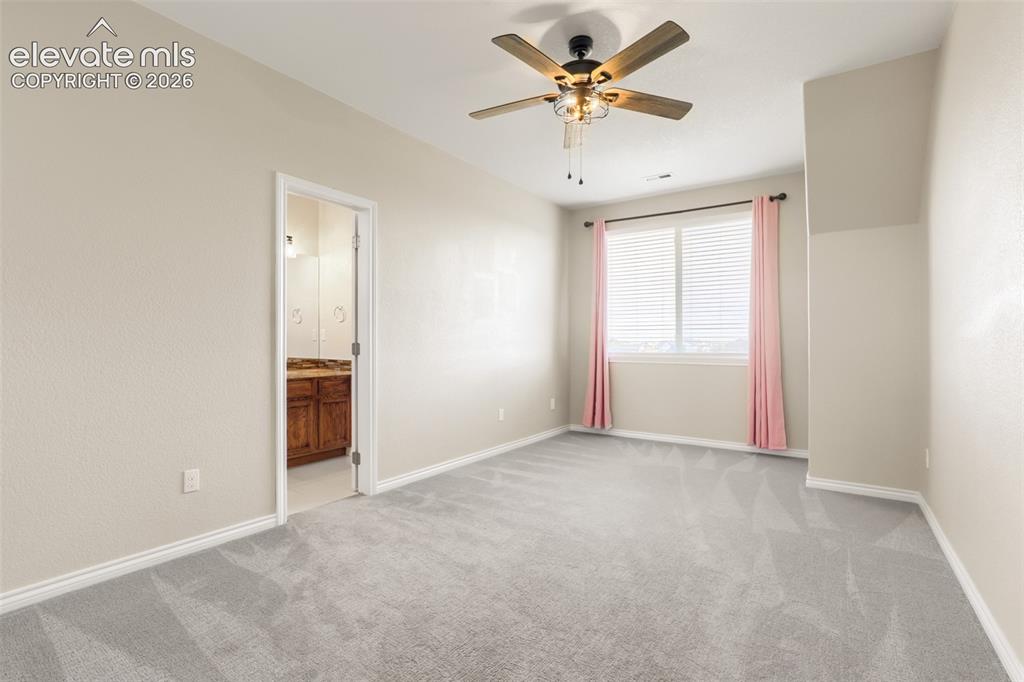 Image 23 of 37: Desirable upper-level end suite featuring wall-to-wall carpet, warm neutral