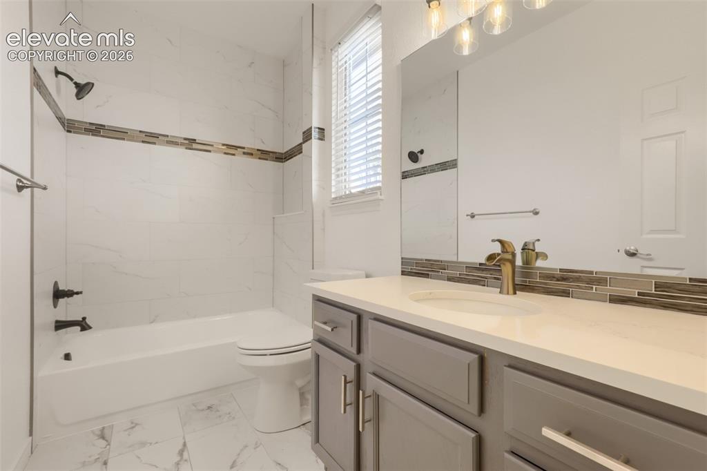 Image 24 of 37: Stylishly updated second-floor full bathroom showcasing modern grey cabinet