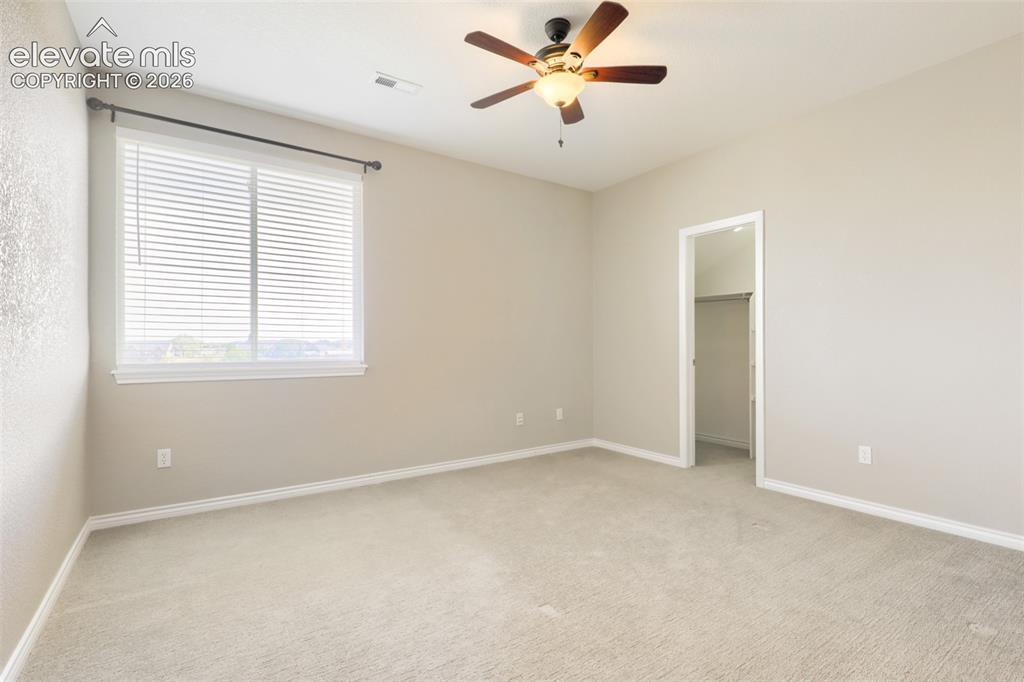 Image 25 of 37: Spacious second-floor bedroom complete with wall-to-wall carpeting, a ceili