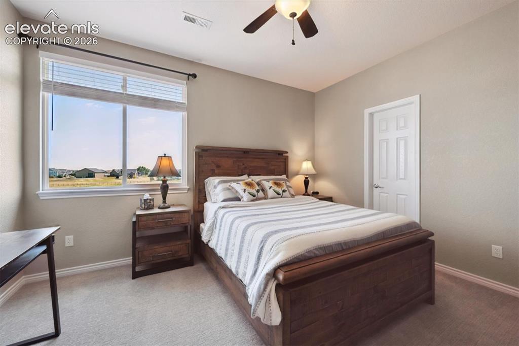 Image 27 of 46: Room featuring a large window with horizontal blinds, neutral wall paint, a