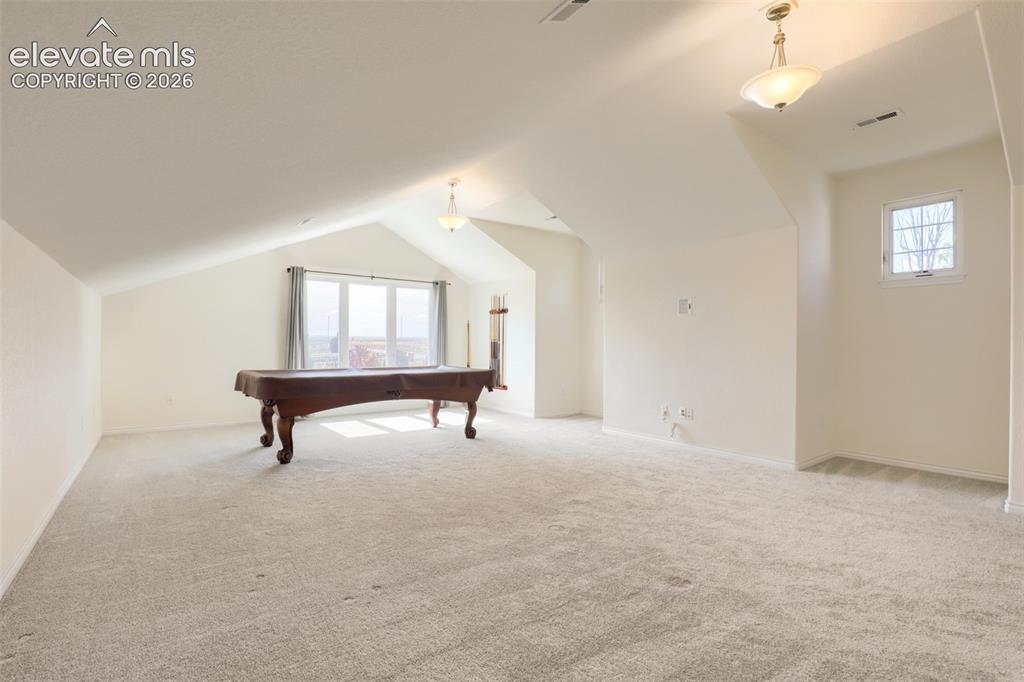 Image 27 of 37: Expansive soundproofed upper-level great room boasting architectural vaulte