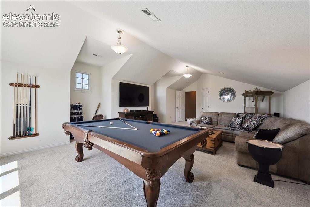 Image 29 of 46: Spacious bonus room featuring sloped ceilings, recessed lighting, and a win