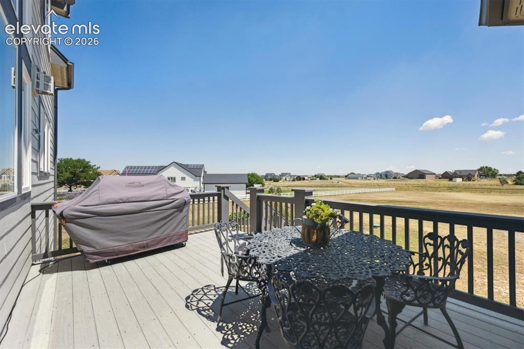 Image 34 of 46: Outdoor deck featuring composite flooring and dark railing