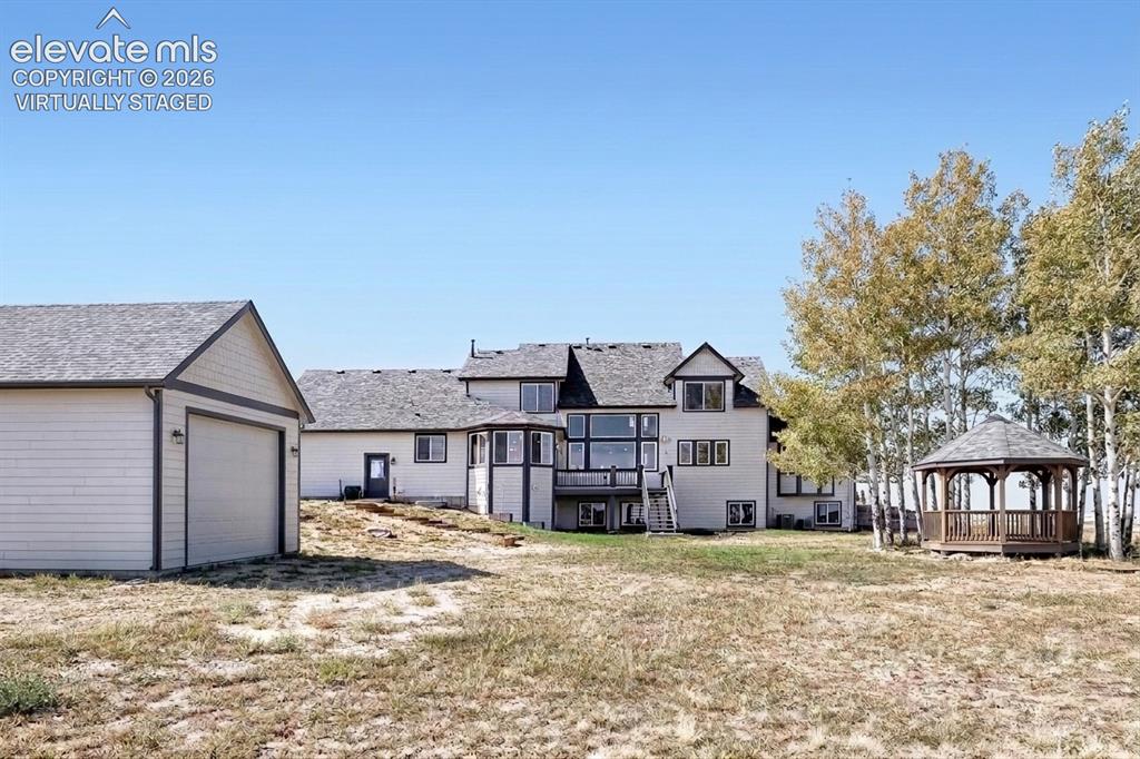 Image 34 of 37: Virtually staged image. The outbuilding and gazebo shown are conceptual ren