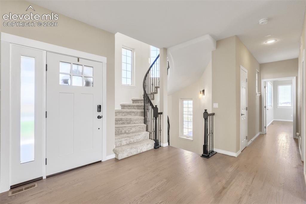 Image 5 of 37: This bright and welcoming foyer features an open layout with neutral-toned