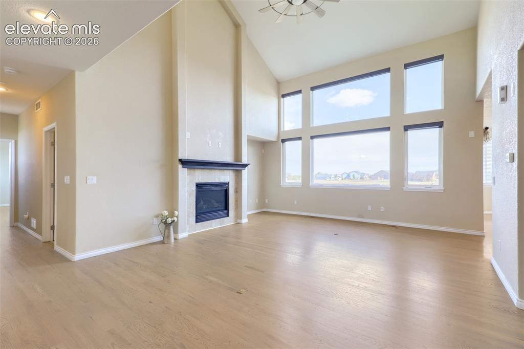Image 8 of 37: Dramatic two-story great room featuring soaring vaulted ceilings, a modern