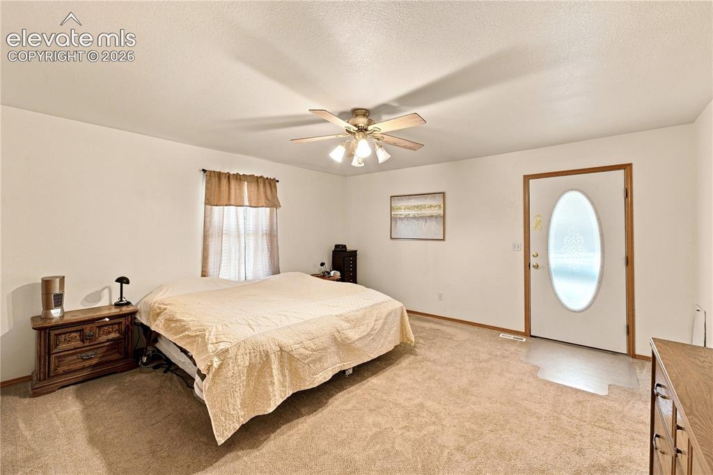 Image 10 of 37: Carpeted room with a ceiling fan