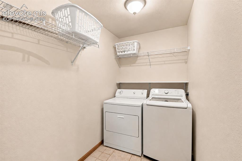Image 23 of 37: Laundry area featuring a tile floor, white appliances, overhead lighting, a