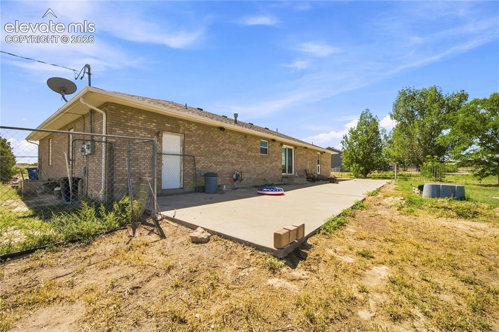 Image 27 of 37: Brick exterior with an extended concrete patio