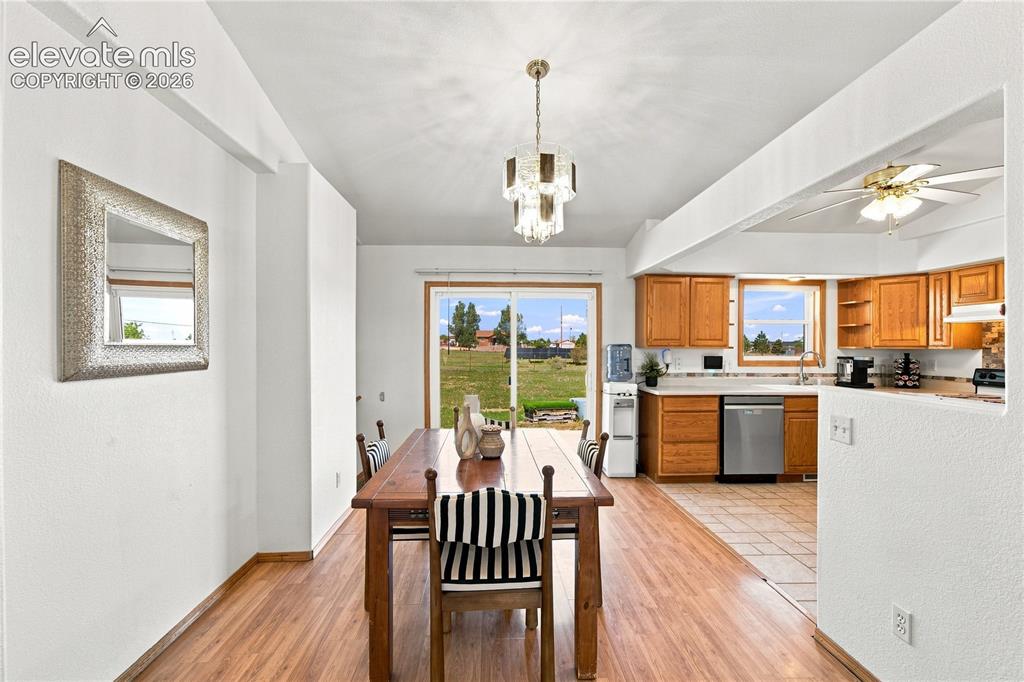 Image 5 of 37: Wood-finish flooring throughout, with a crystal chandelier and recessed cei