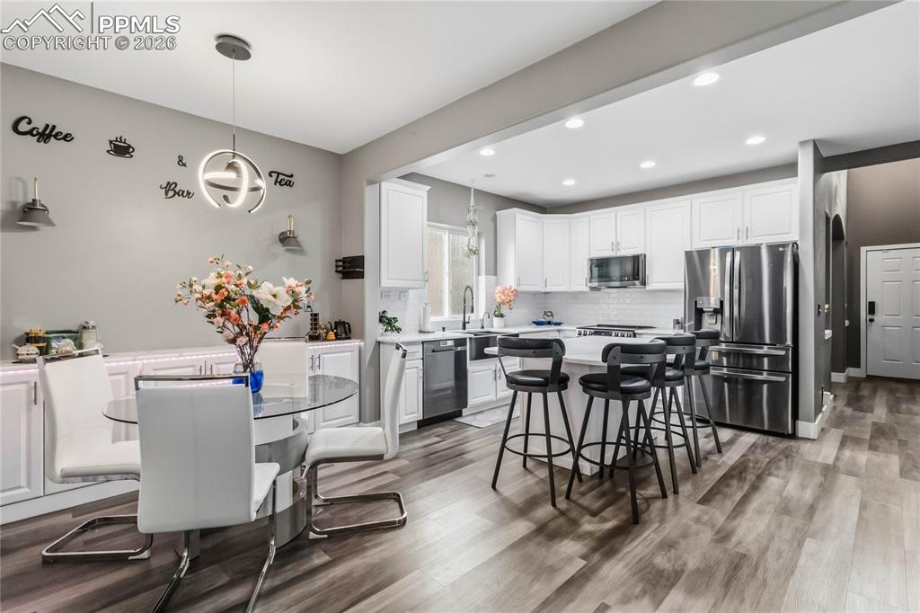 Image 11 of 43: Spacious kitchen and dining area featuring a coffee or wine bar with extra 