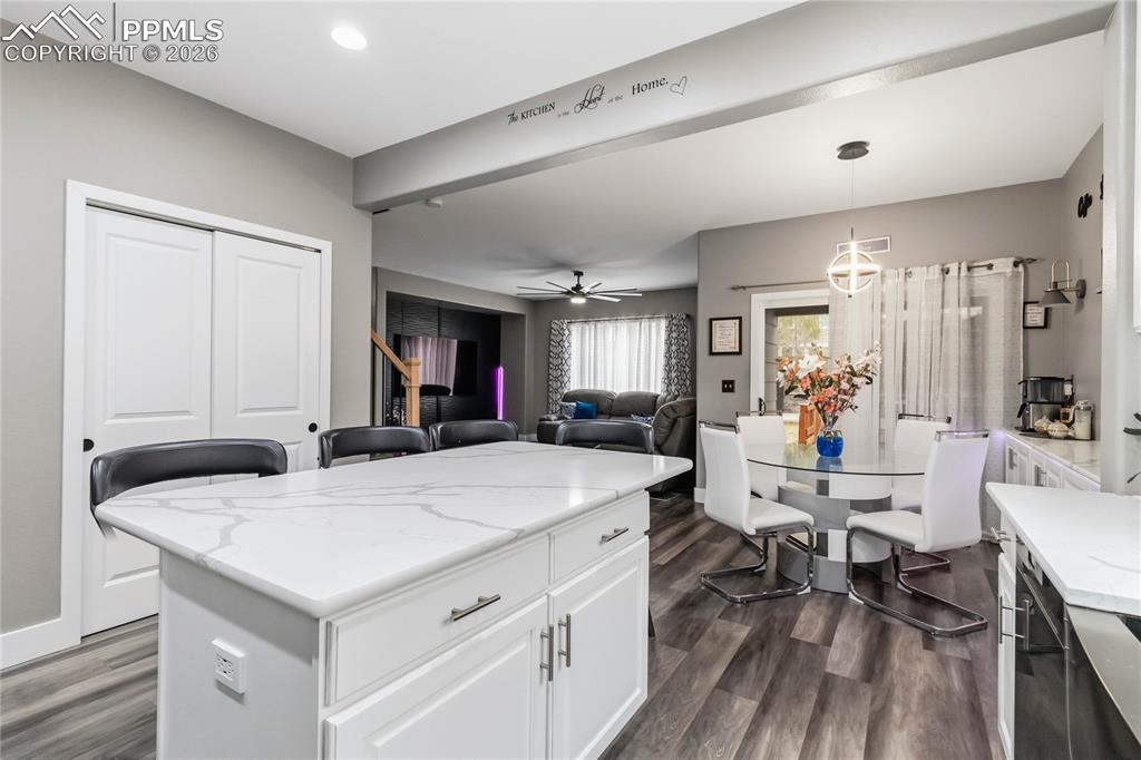 Image 14 of 43: The kitchen area with pantry behind island. 