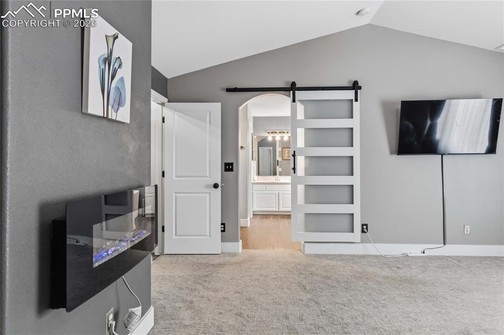 Image 22 of 43: Bedroom with Barn door to Bathroom