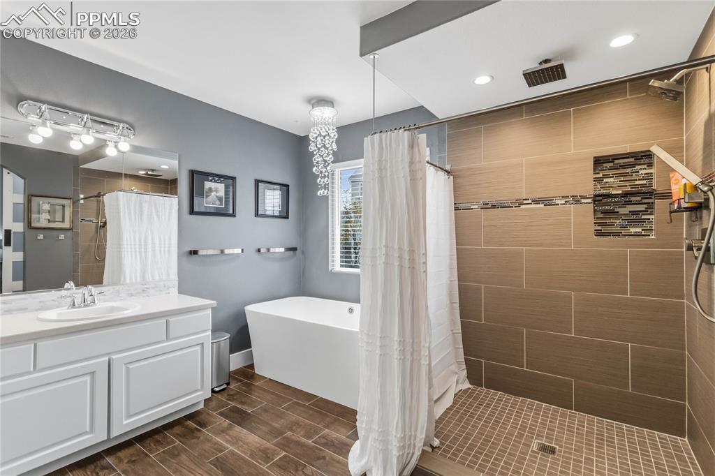 Image 27 of 43: Master Bathroom featuring a spacious walk-in shower with tiled walls and a 