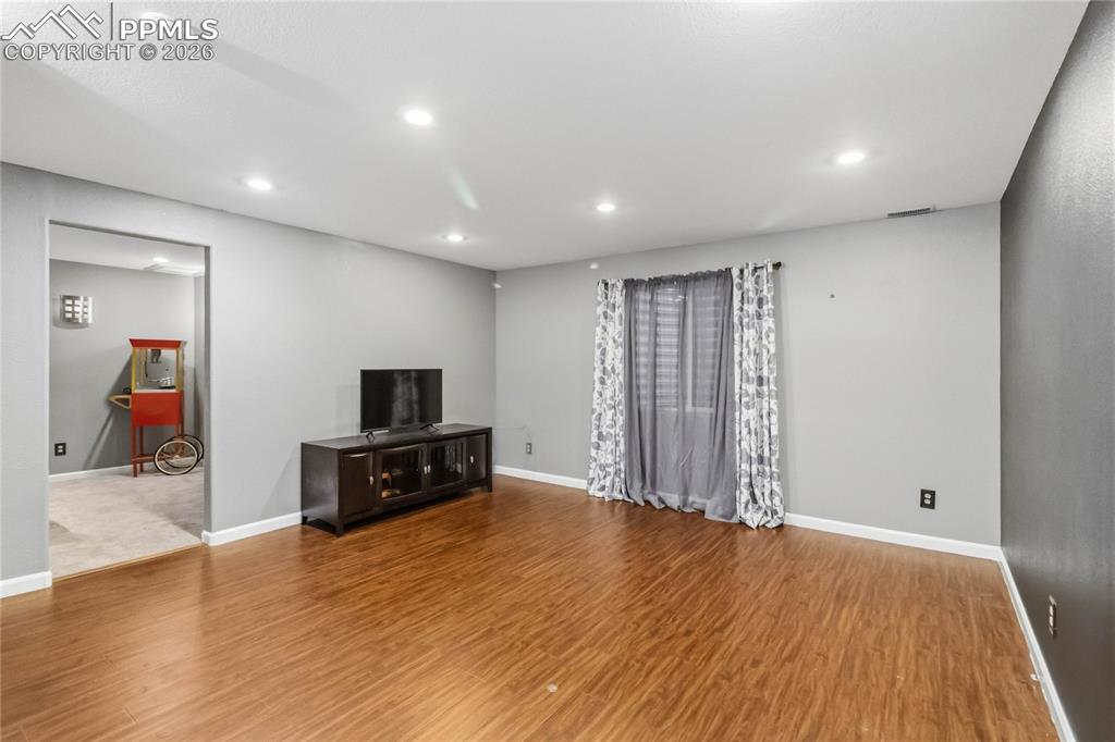 Image 31 of 43: Basement Family room - lots of possibilities! Small media room to the left.
