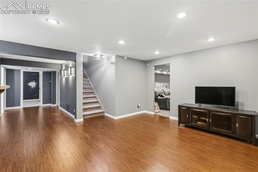 Image 32 of 43: Basement living room area.  Bedroom off to the left.