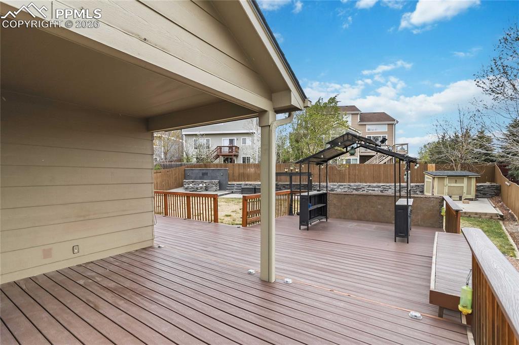 Image 38 of 43: An expansive outdoor deck provides ample space for entertaining, featuring 