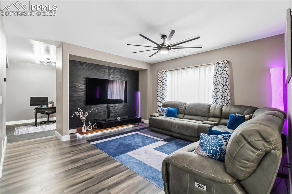 Image 7 of 43: Gorgeous living room with custom TV wall and lots of natural light. 