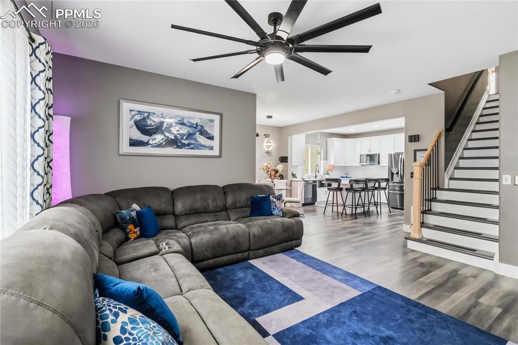 Image 9 of 43: Living room and LVP stairway going upstairs to 4 bedrooms!