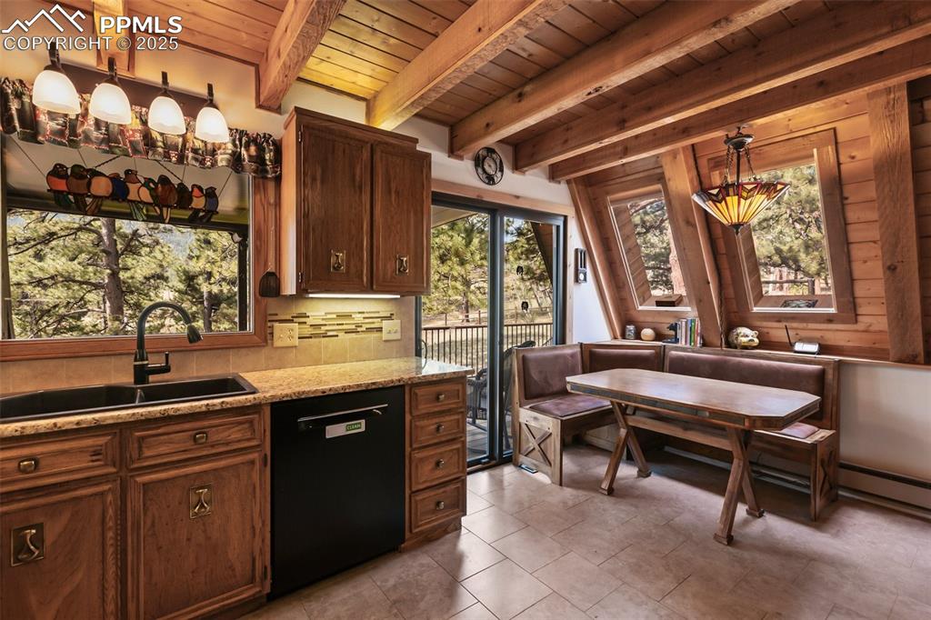 Image 10 of 50: beautiful kitchen steps out onto the covered deck