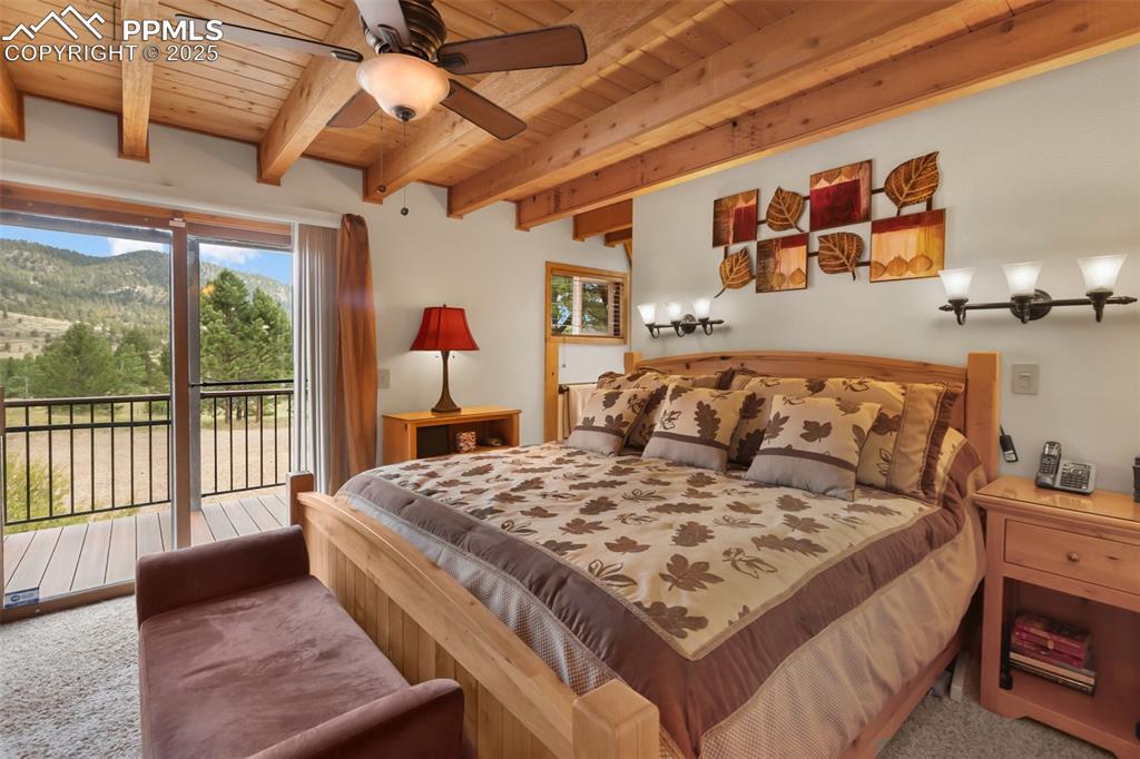 Image 13 of 50: Main level bedroom with large deck and attached bath