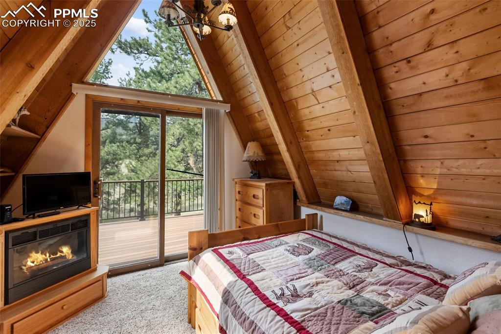 Image 17 of 50: Upper level bedroom with private deck