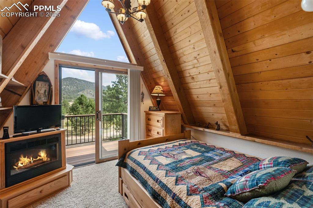 Image 20 of 50: Upper level bedroom with private deck