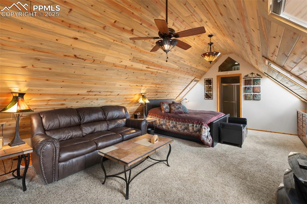 Image 29 of 50: Inside of cabin 1 showing large sitting area and bedroom
