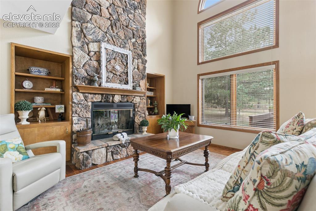 Image 10 of 50: Floor to Ceiling Stone Fireplace & Built-in Bookcases...Perfect for Those C
