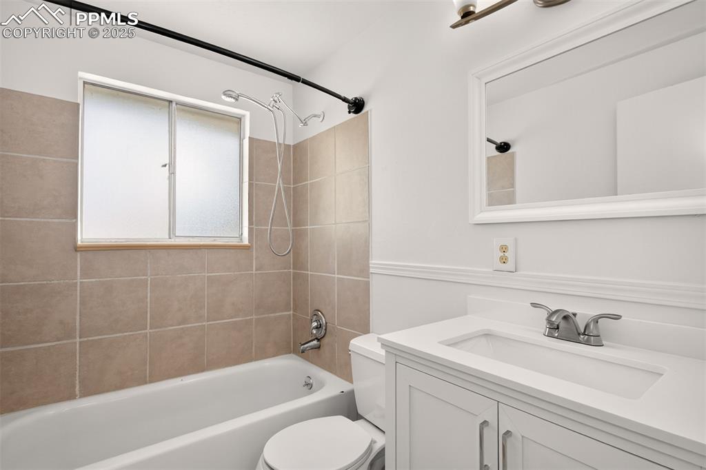 Image 11 of 17: Full bath with vanity and shower/ tub on main floor.
