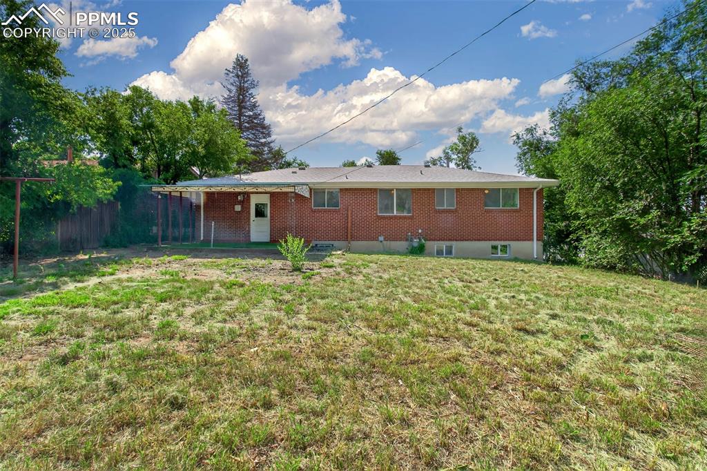 Image 2 of 17: Rear view of property with brick siding