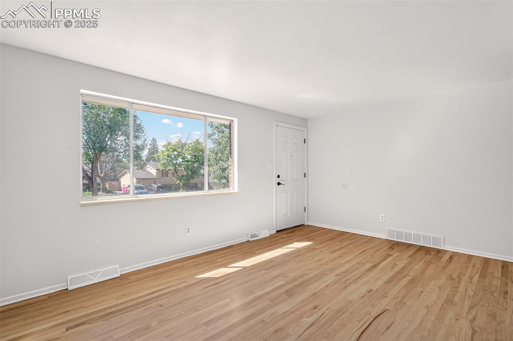 Image 3 of 17: Living room with light wood-style floors