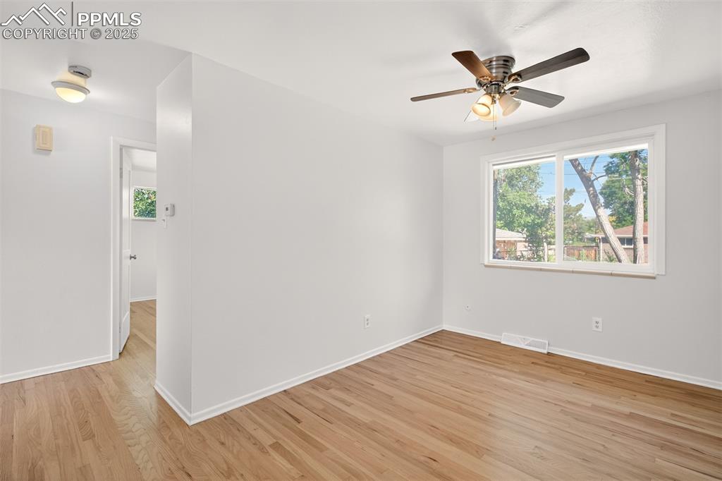Image 8 of 17: Spare room featuring light wood-style flooring, a ceiling fan, and a smoke