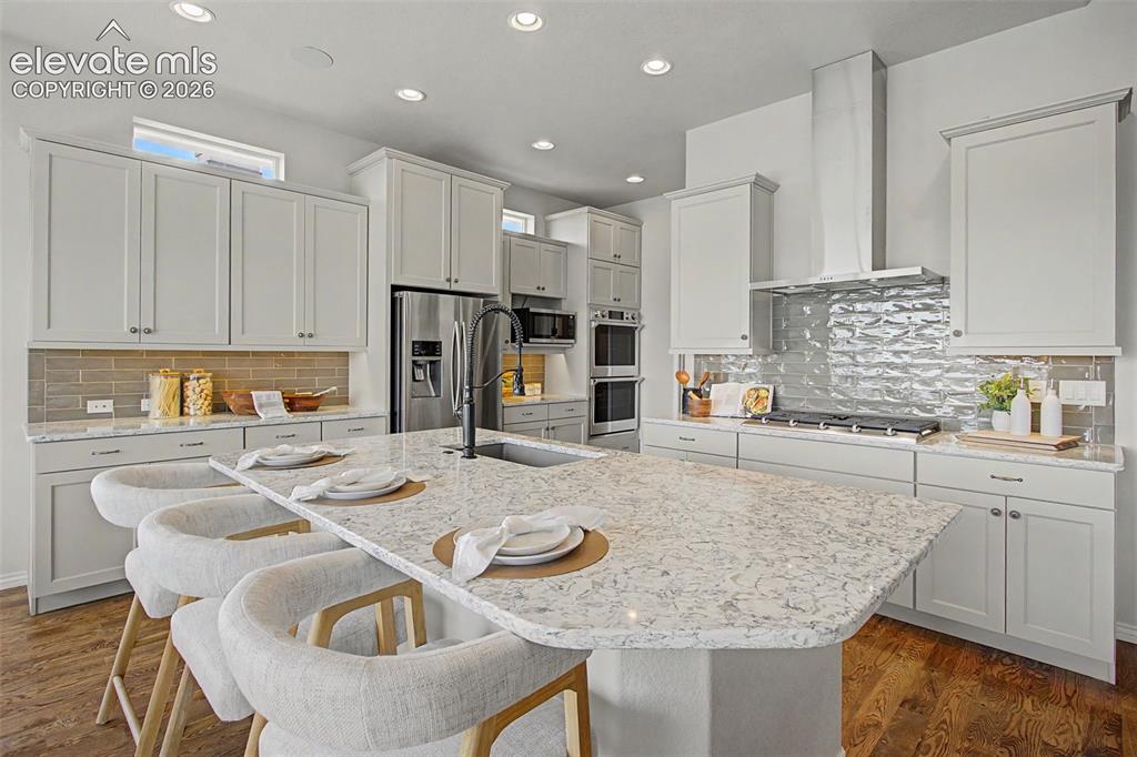 Image 13 of 50: Double ovens, gas cook top and stainless hood
