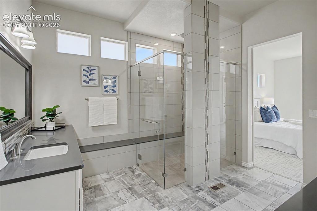 Image 21 of 50: Spa like primary bathroom with heated tile flooring and zero entry shower