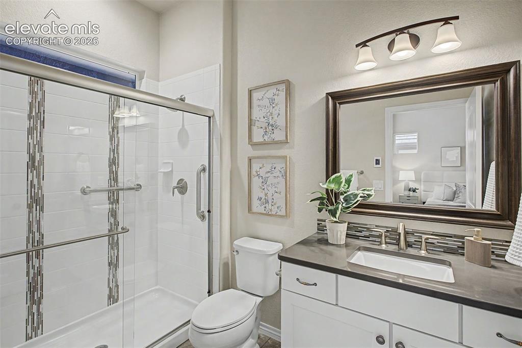 Image 28 of 50: Attached en-suite bathroom with heated tile floors