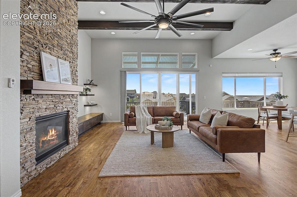 Image 6 of 50: Cathedral beamed ceilings and rocked fireplace highlight the space
