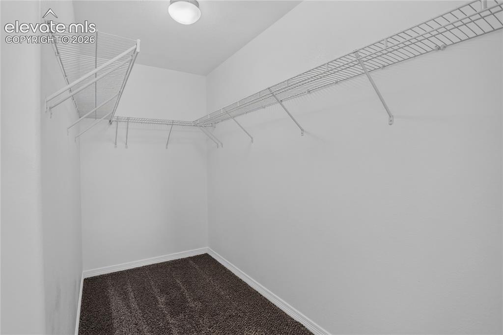Image 11 of 20: Primary walk-in closet