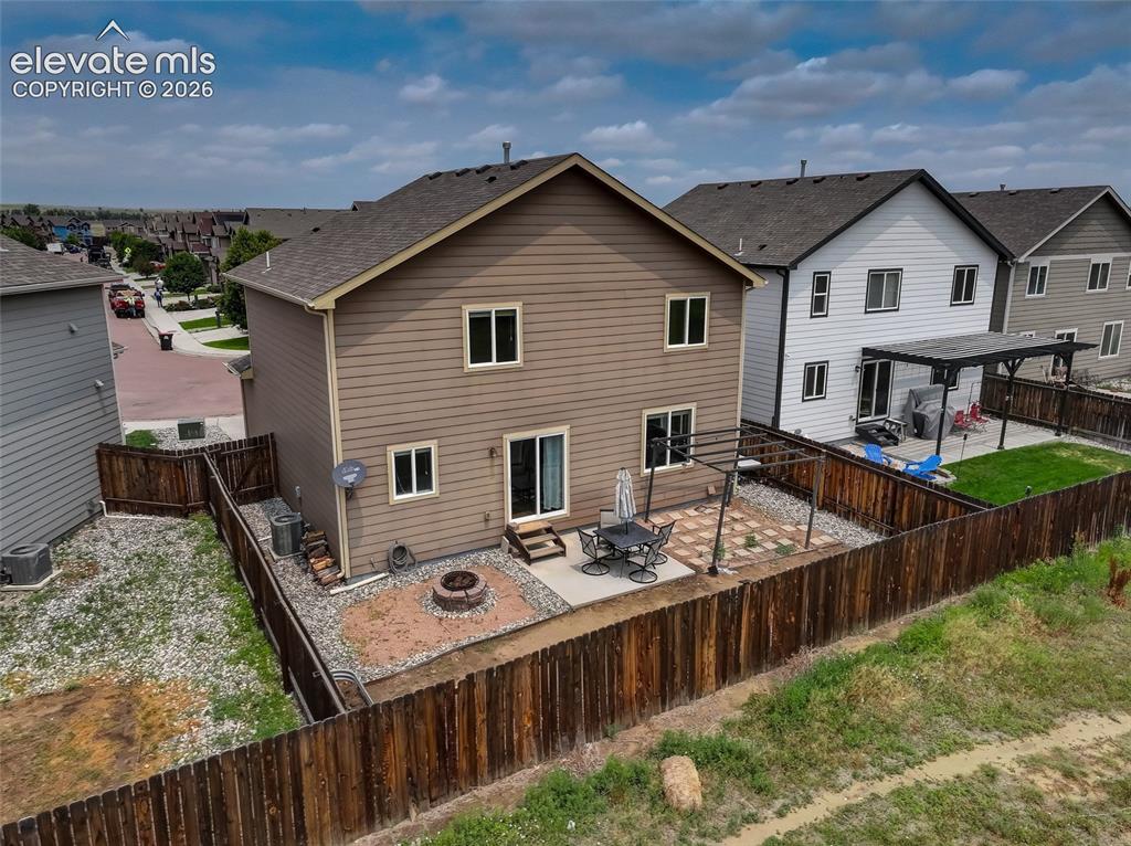 Image 16 of 20: Fully fenced backyard w/ pergola & firepit