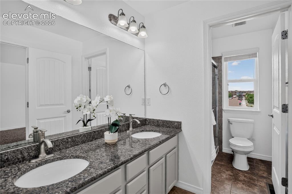 Image 9 of 20: Primary bath features dual sink vanity