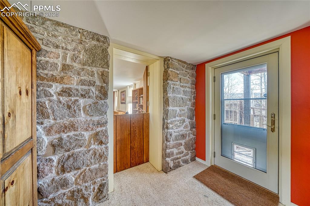 Image 29 of 37: Stunning stone wall with the original dutch door.