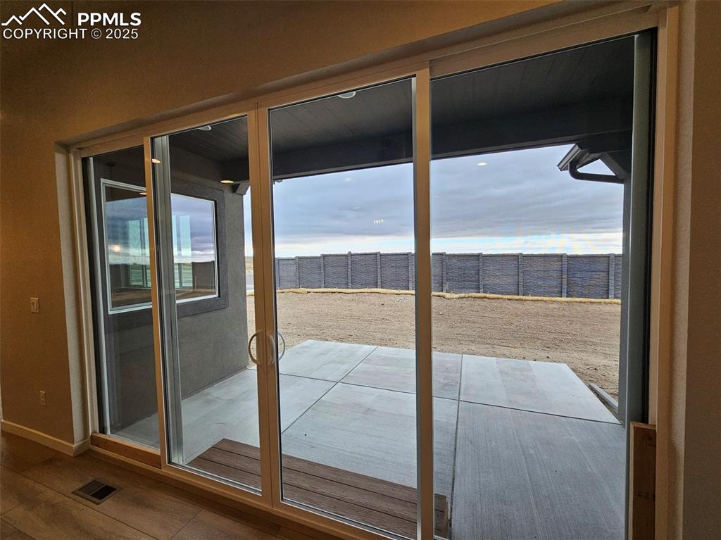 Image 11 of 24: Sliding glass doors to back patio
