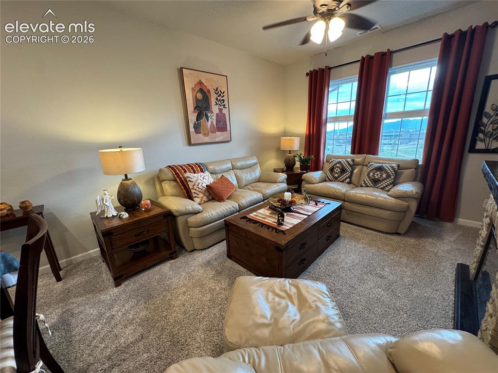 Image 11 of 25: Neutral carpeting, double-pane windows, ceiling fan with integrated lightin