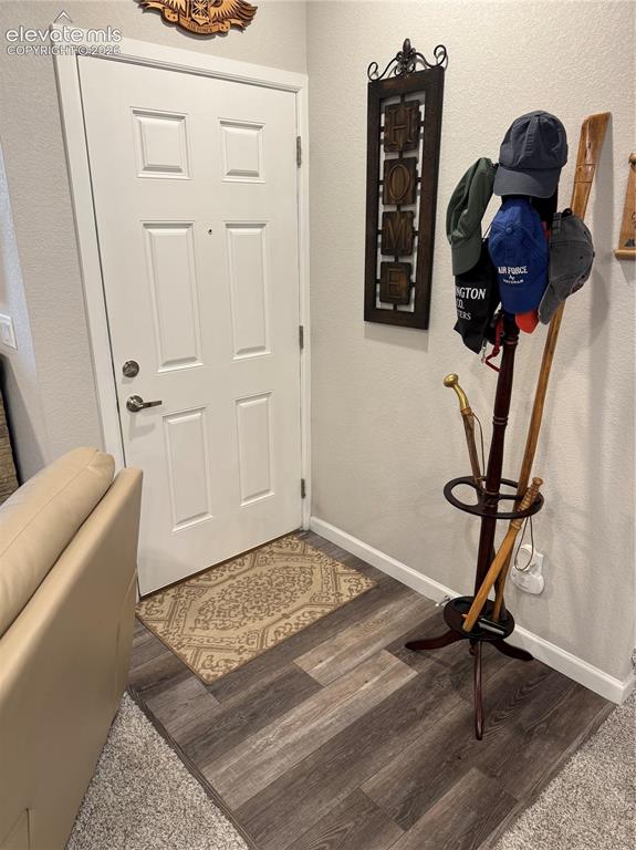 Image 24 of 25: Entryway featuring a white paneled door with brushed nickel hardware and wo