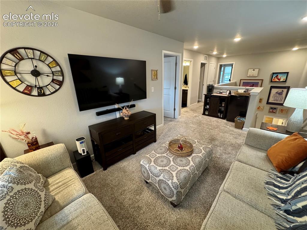 Image 9 of 25: Neutral wall tones, recessed lighting, and wall-to-wall carpeting