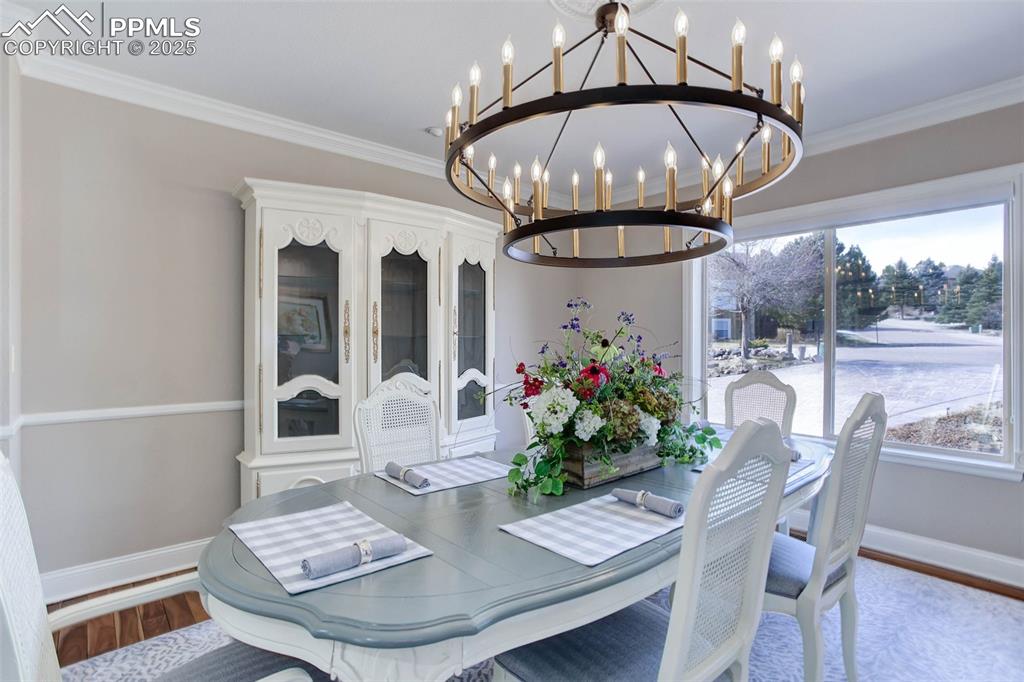Image 7 of 50: large triple windows with custom Hunter Douglas Shades, deep baseboards and