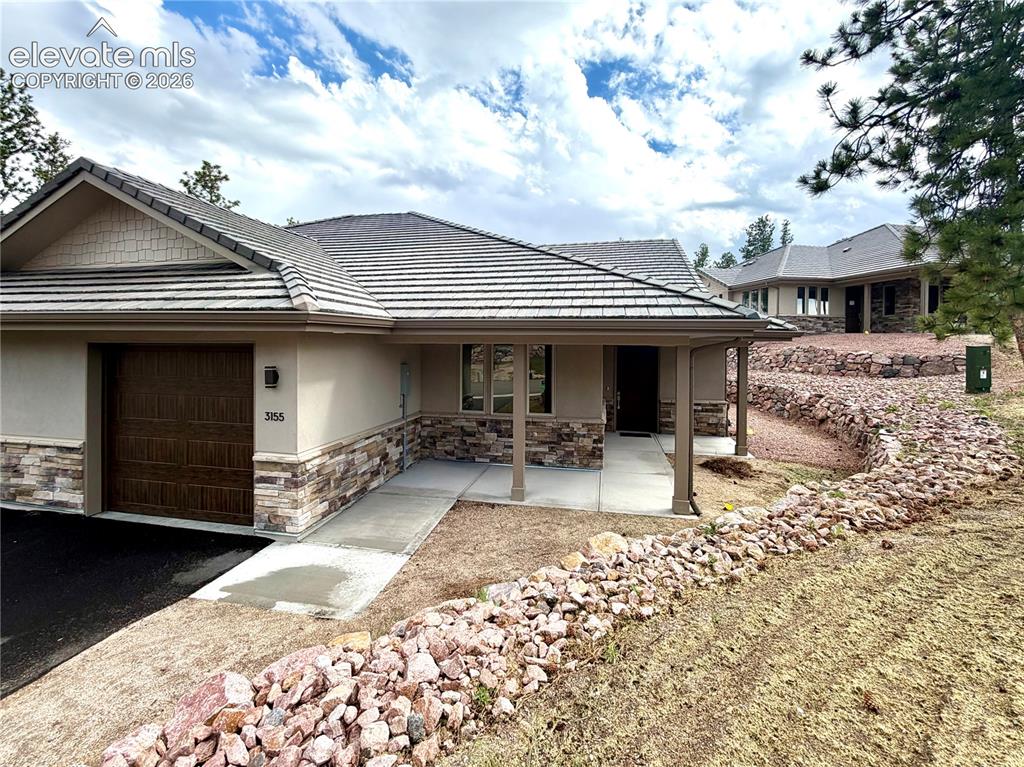 Image 1 of 29: Stone and Stucco exterior with tiled roof make this low-maintenance.