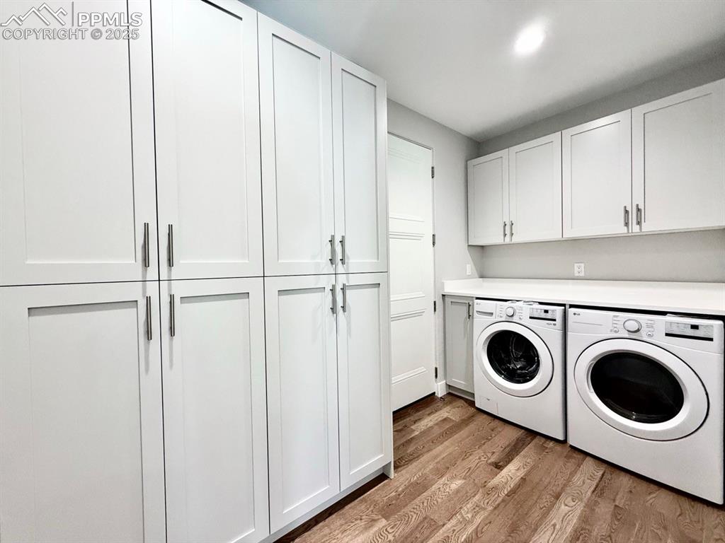 Image 13 of 29: Laundry Room & Pantry with Wood Flooring.